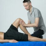 male physiotherapist helping client